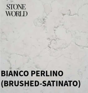A polished white quartz worktop with subtle veining, complementing a bright kitchen.