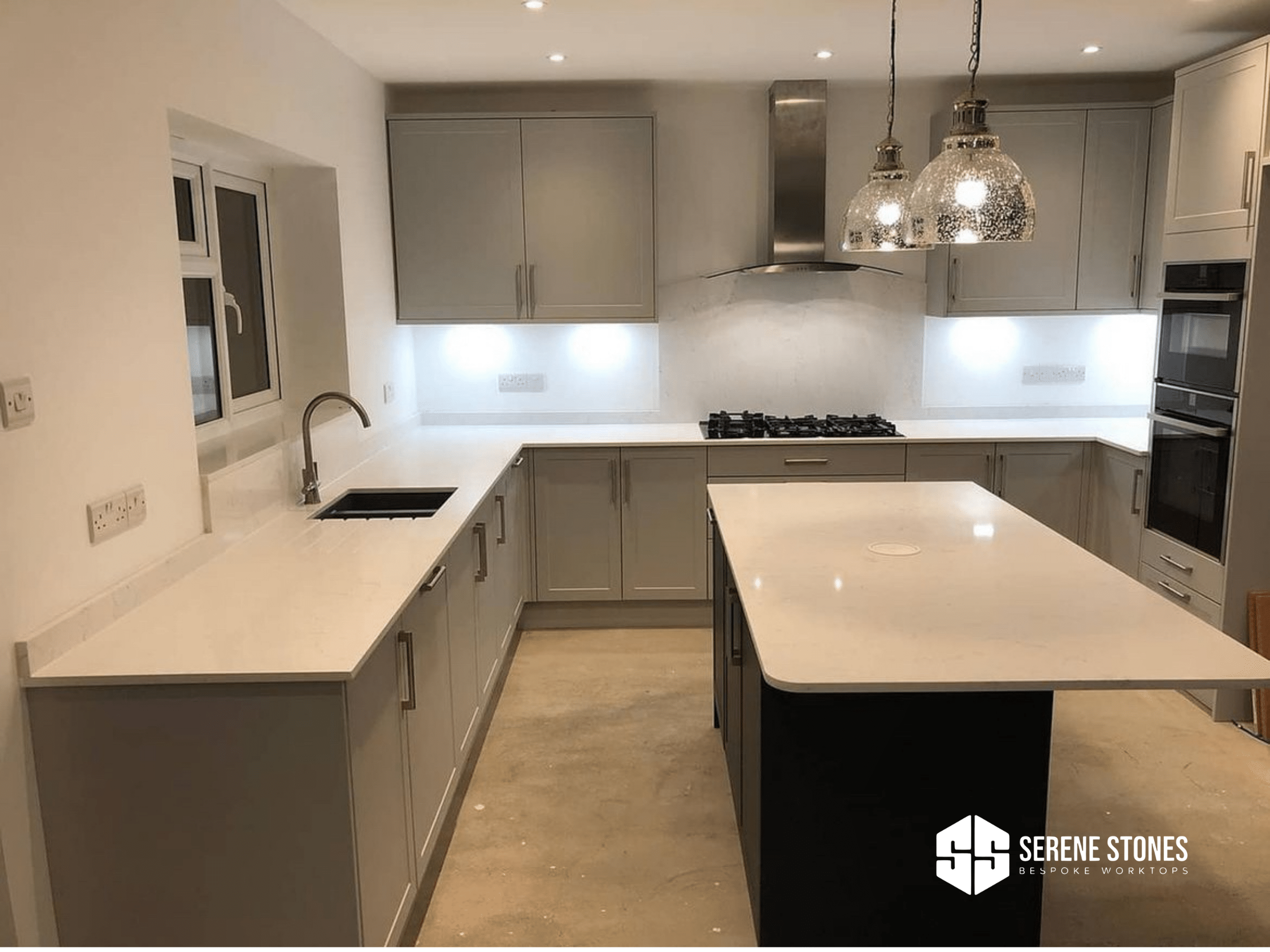 Seamless quartz worktops for a smooth kitchen finish.